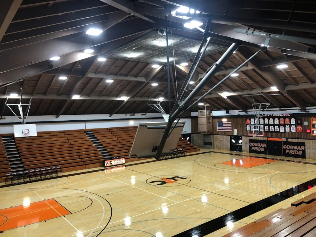 Gymnasium with broadcast-ready LED lighting providing flicker-free illumination for streamed athletic competition